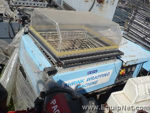 Shrink wrapping machine